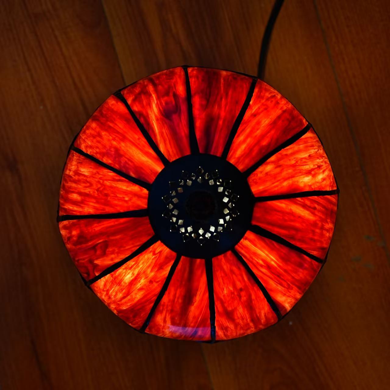 Image 5. Top view of the completed illuminated sample, showing radial red glass panels and the decorative cap.