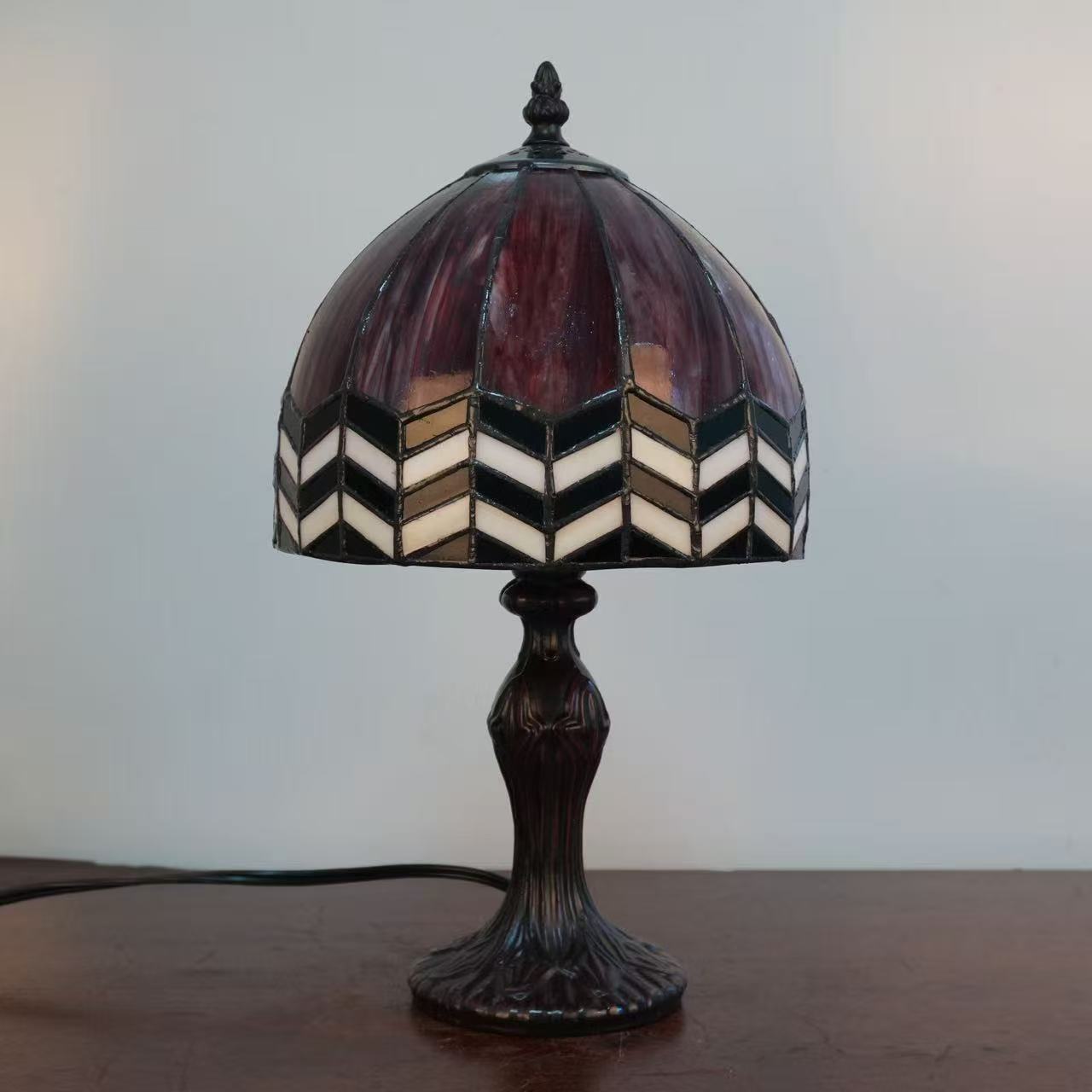 Image 6. Completed sample with the light off, showing the deep red glass, pale chevrons and dark-finished base.